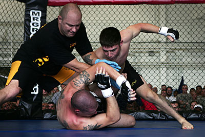 John Renken refereeing US Army combatives tournament