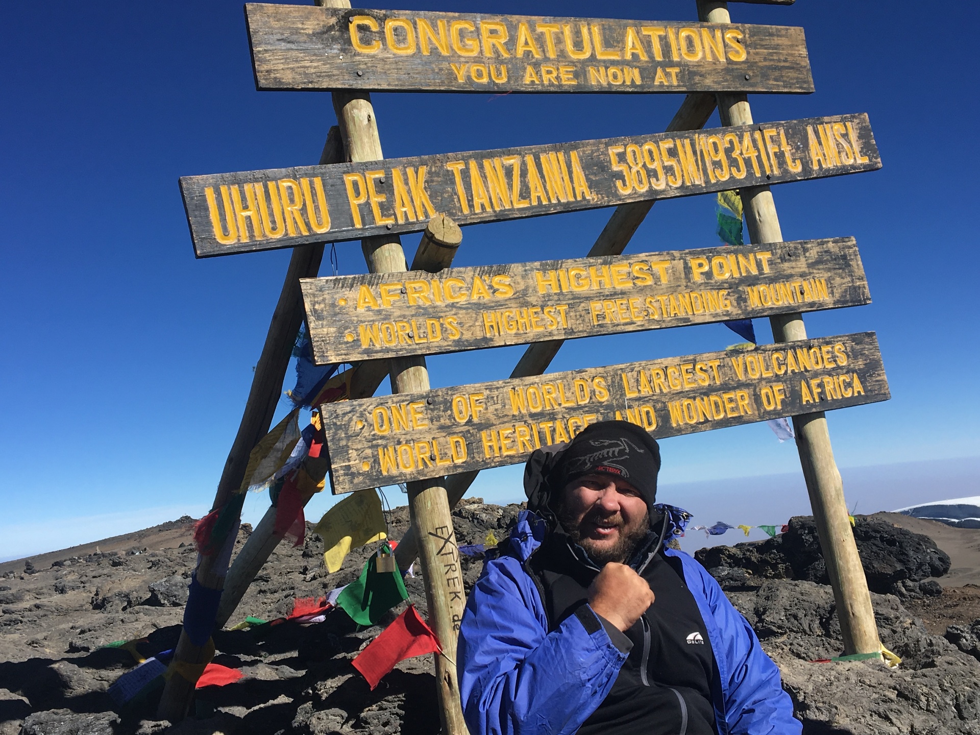 John Renken summiting Mount Kilimanjaro